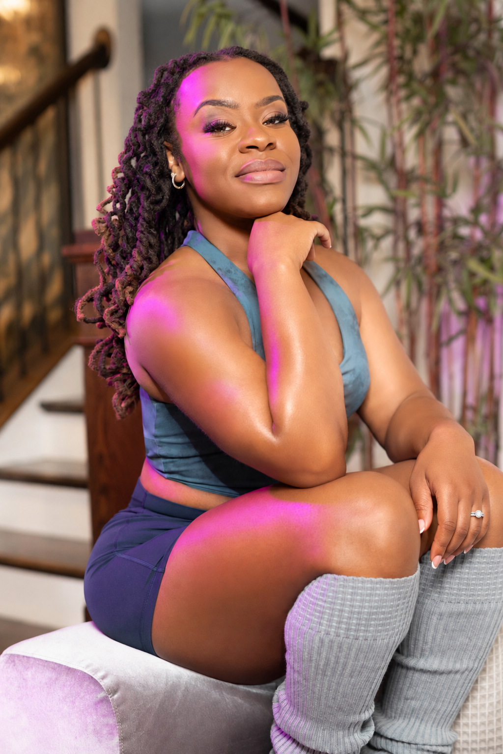 Coco seated in a blue movement look wearing her wedding ring