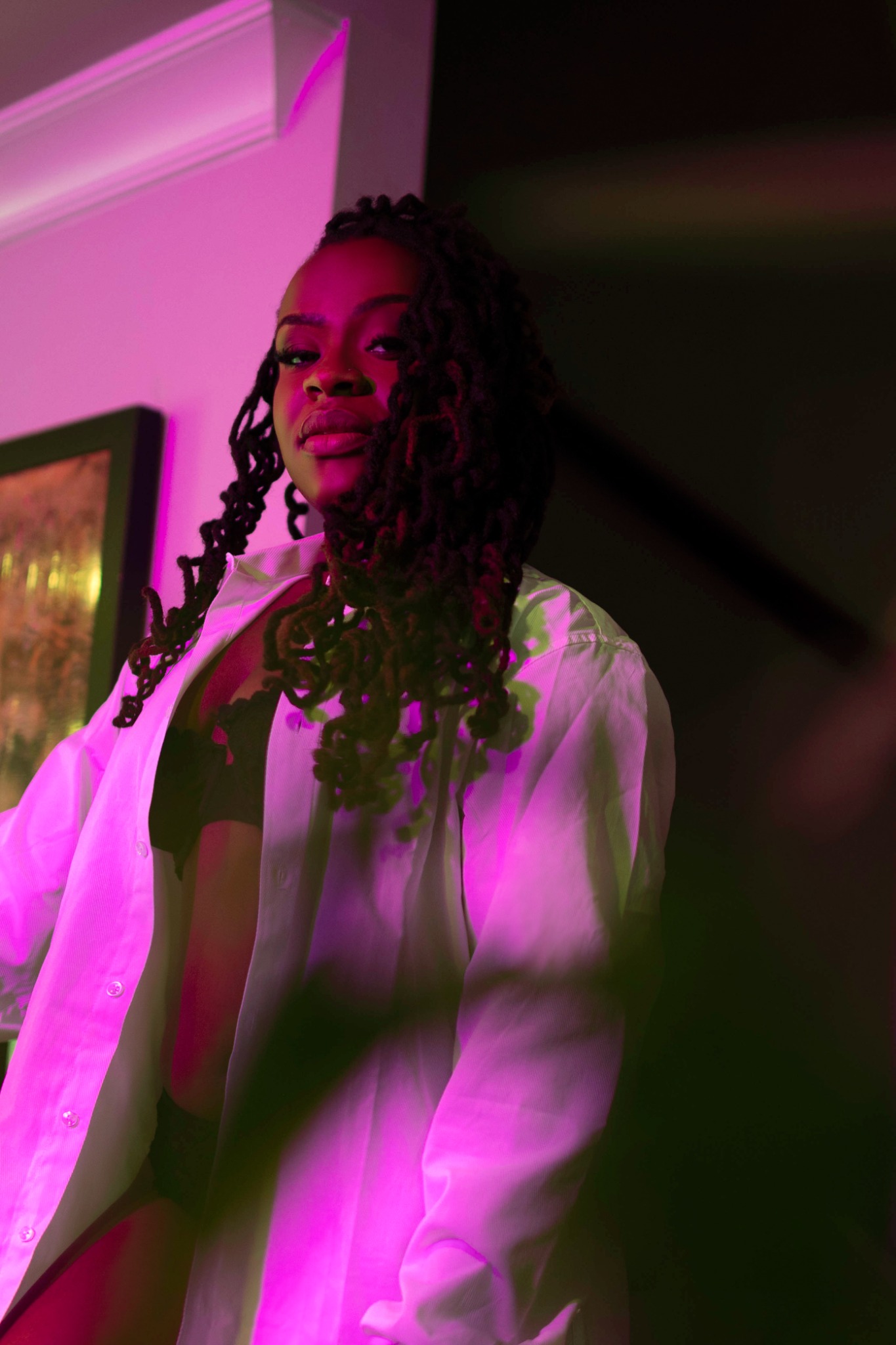 Coco in a pink lit editorial portrait