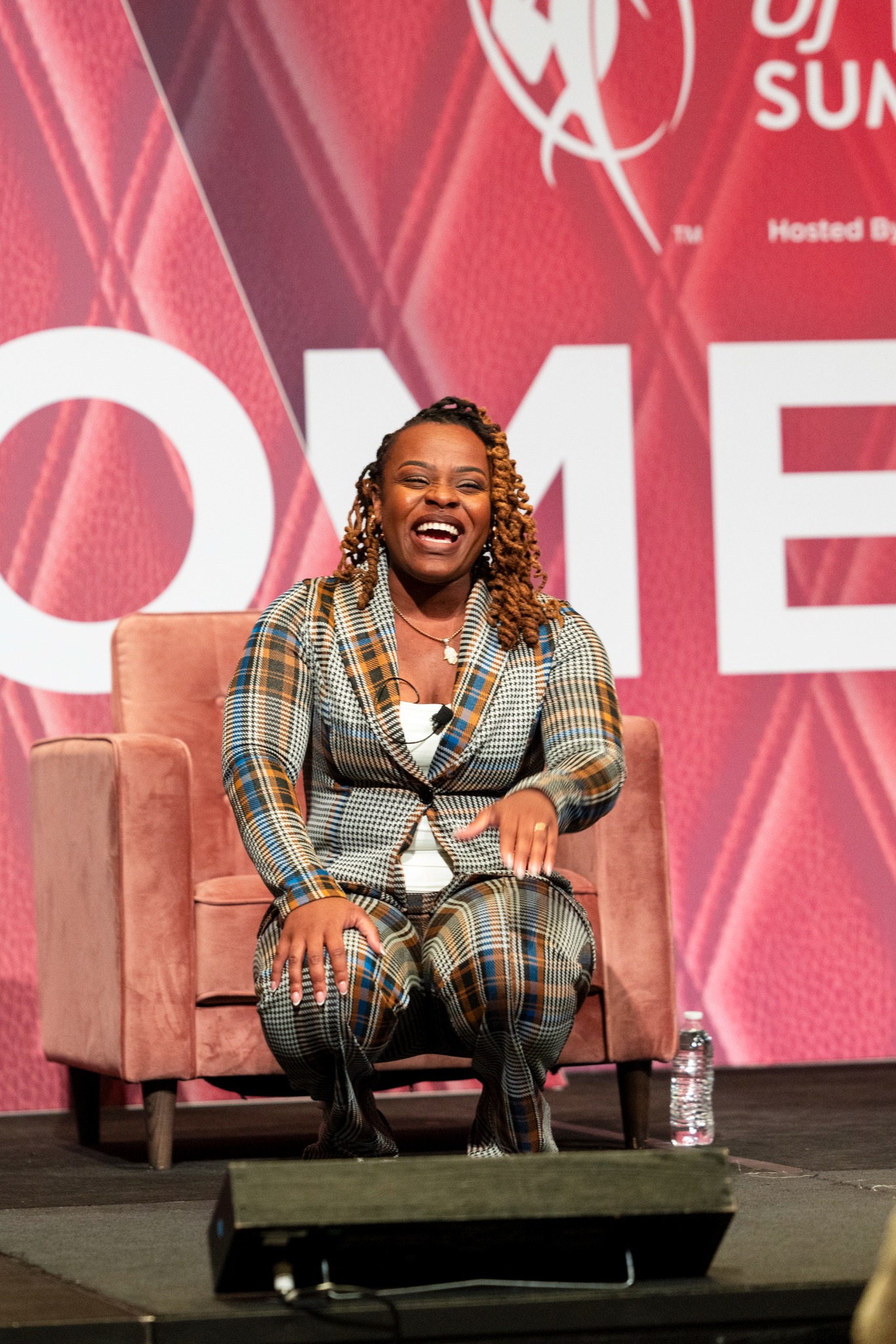 Coco seated on stage during a Women of Power Summit conversation